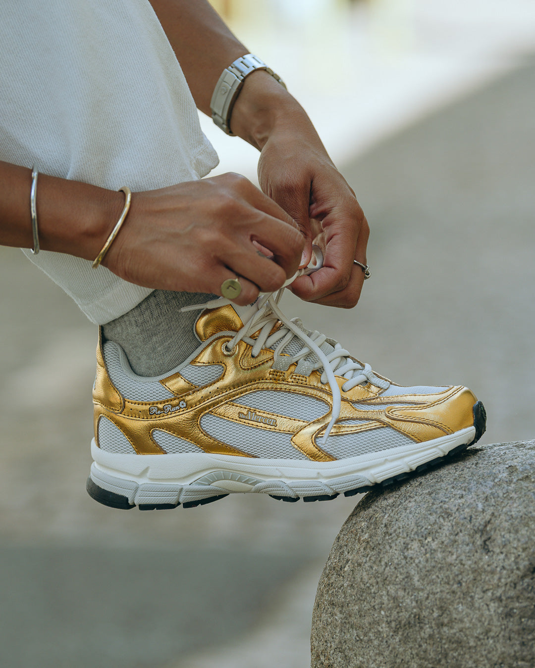 the mercer brand sneaker the re-run pine gold with off white details for women open foot close up 