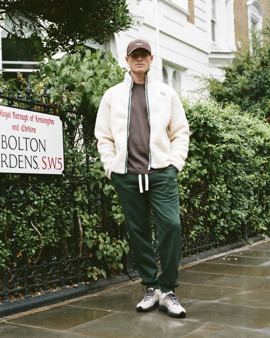 the mercer brand the re-run outdoor sneaker cream with dark details and water repellent upper full look for men with sweatpants green, brown shirt and wool zip vest