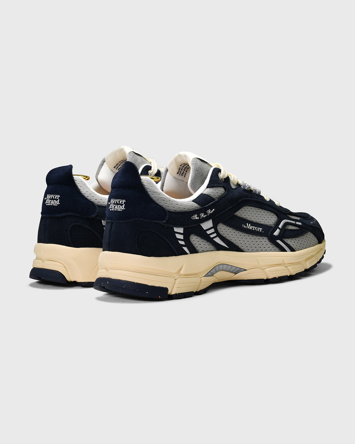 the mercer brand sneaker the re-run vintage navy with grey details and off white outsole