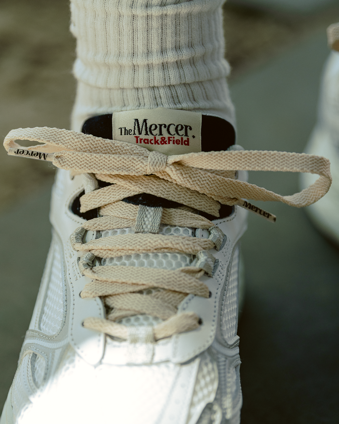 the mercer brand re-run max sneaker track and field white sneaker with cream laces and small navy details 