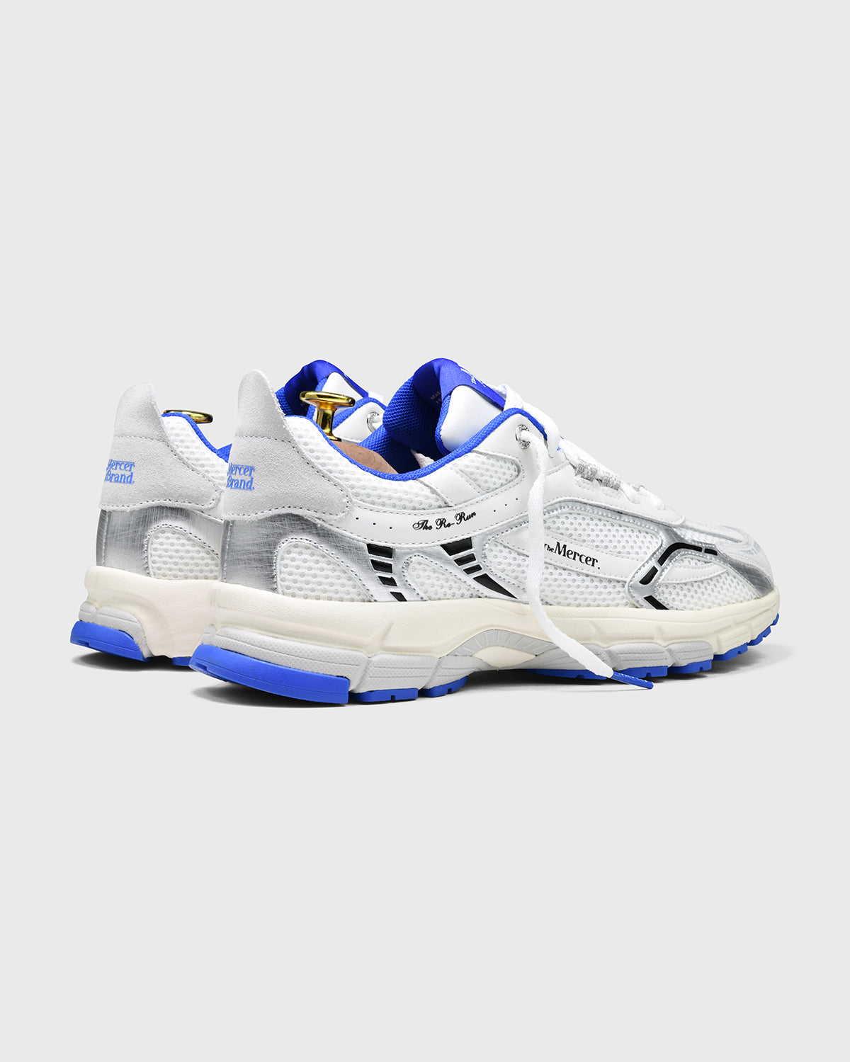 Product photo taken at an angle from the back of The Re-Run White/Silver in White/Blue.