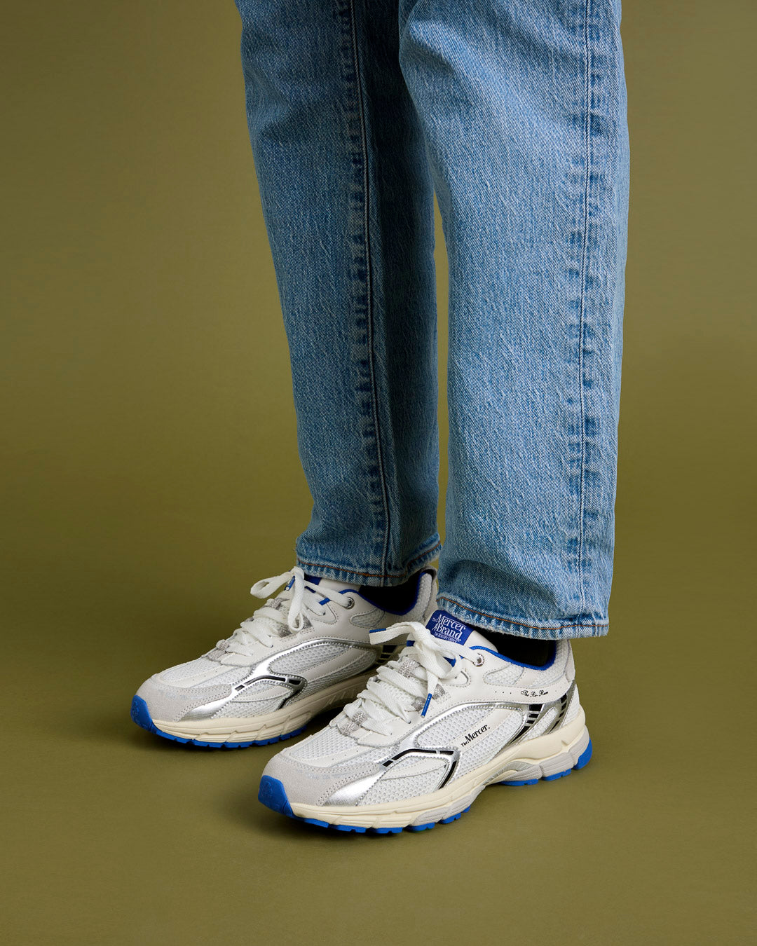 A man is wearing a jeans with The Re-Run White/Silver in White/Blue.