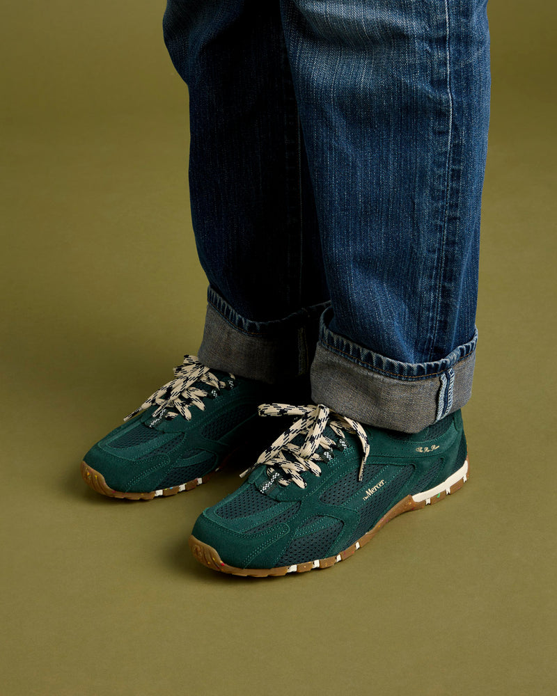 Woman wearing a jeans with the Re-Run Drive in green.