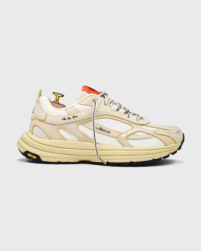 Product shot of the Re-Run Vibram in Off White from the side orange detail and thick sole sneaker by the mercer brand