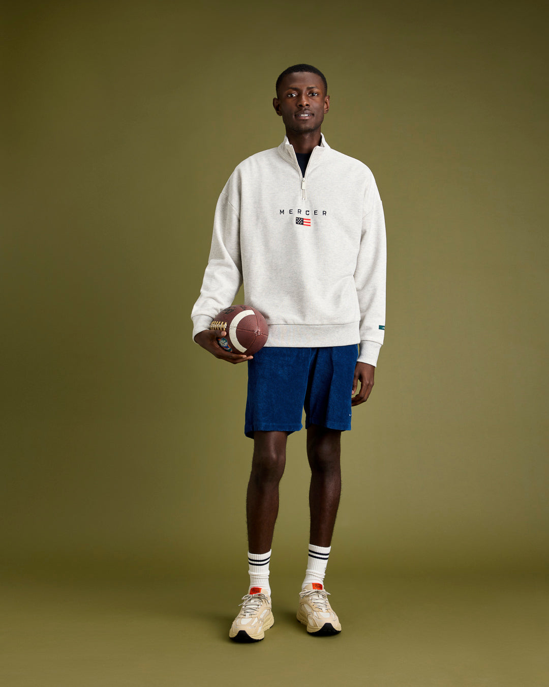 full look shot on model with aparel from the mercer brand wearing a white quarter zip, blue terry shorts and the The Re-Run Vibram in Off White by the mercer brand
