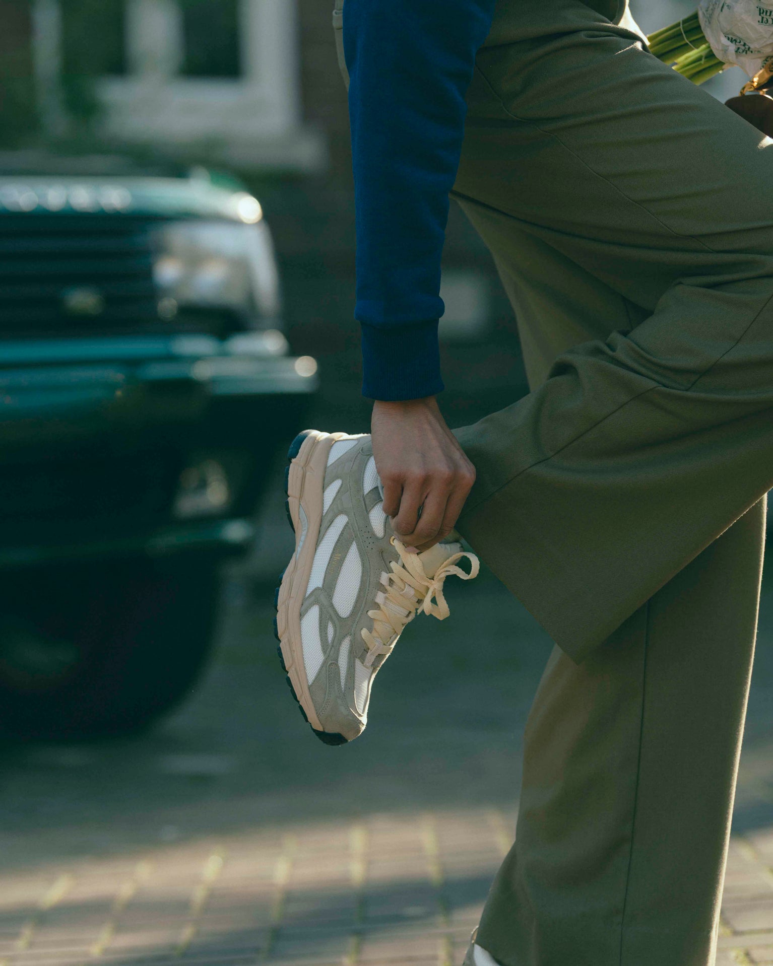 a woman is wearing The Re-Run Desertt 2.0 in sand.