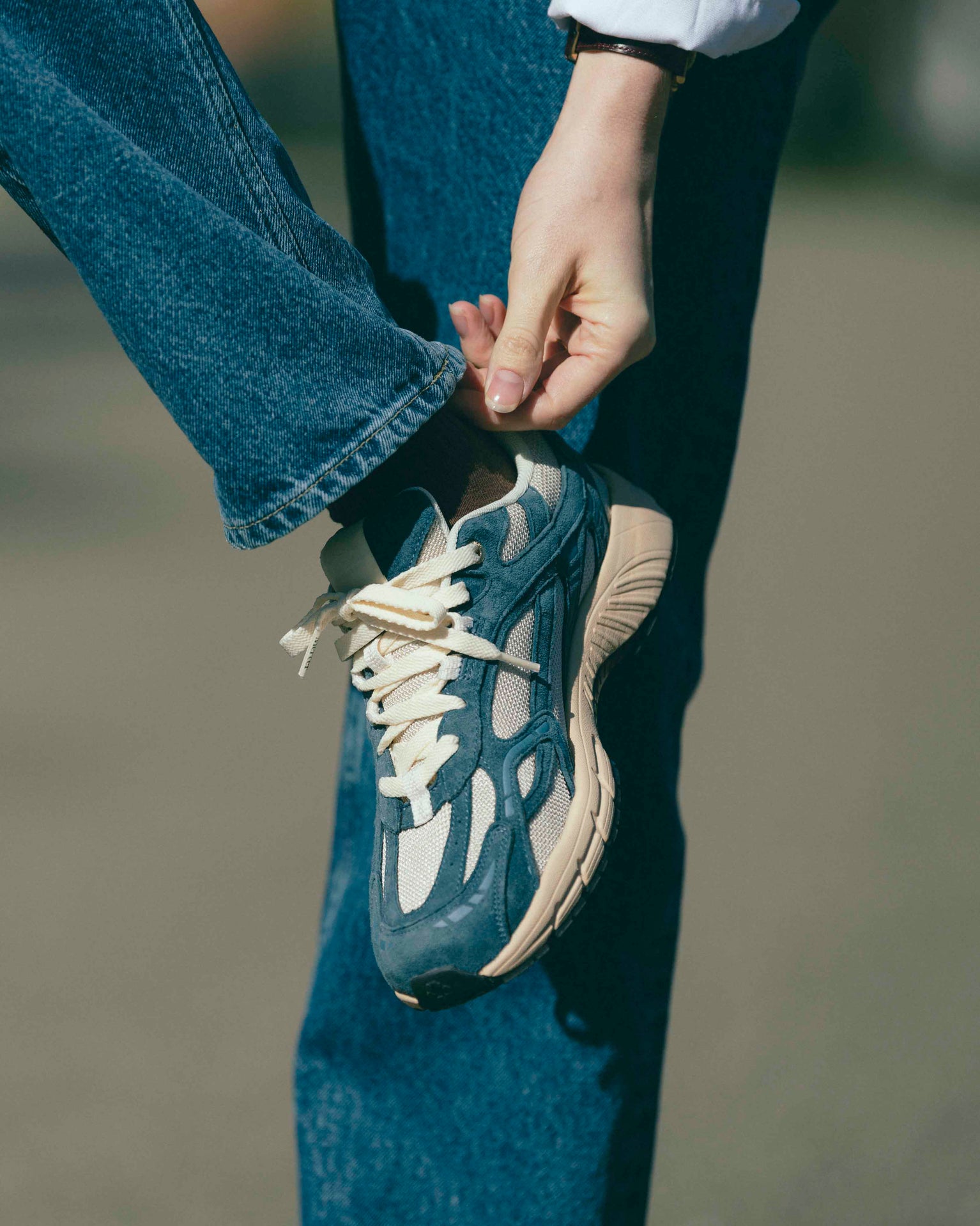 A woman who is wearing The Re-Run Desert 2.0 in  blue/blue.