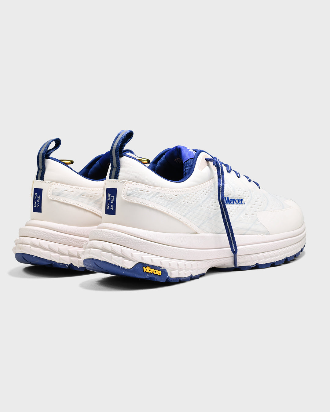 Product photo taken from an angle of the back showing The Mercer P22 in white/blue and the Vibram sole.