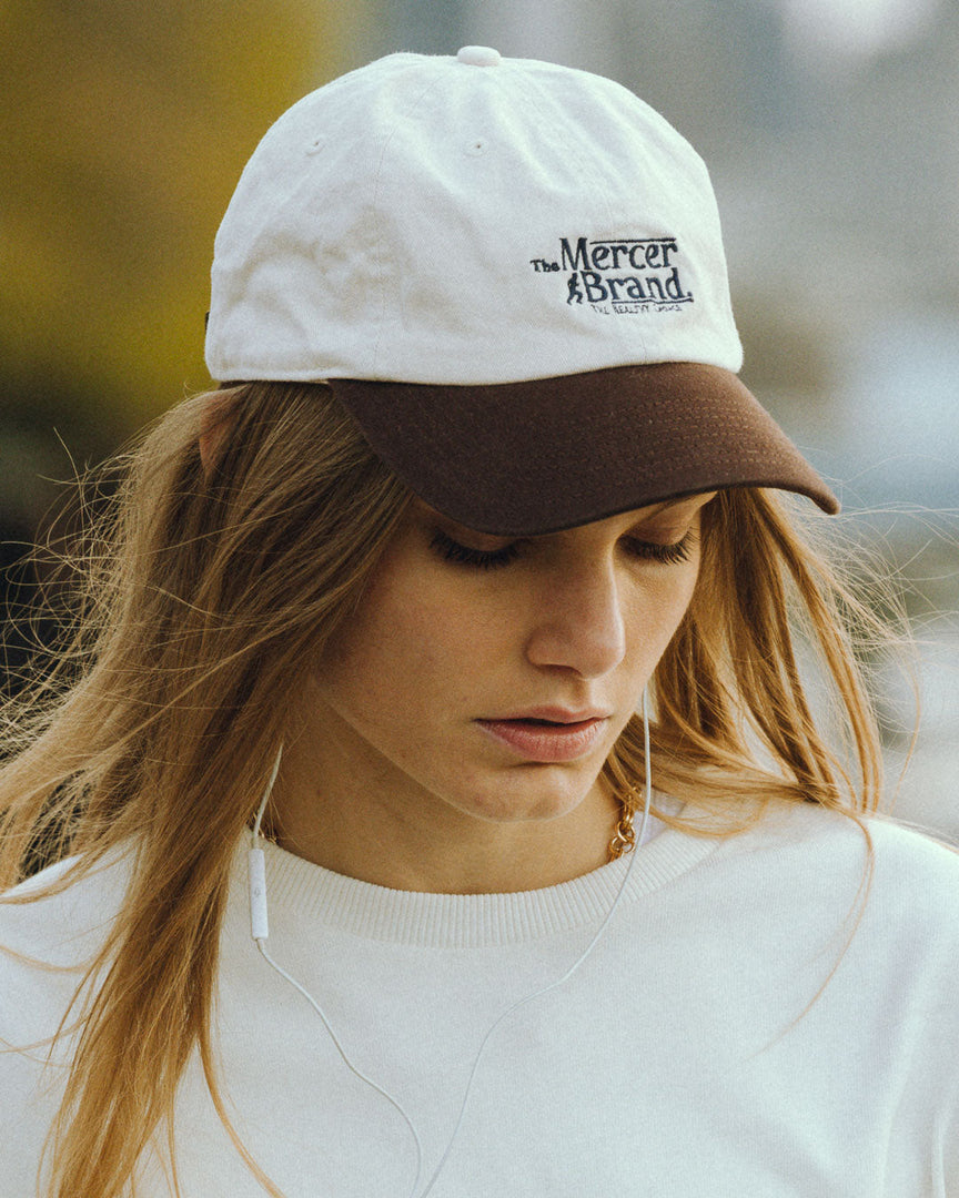 the mercer brand cap off whit combined with brown details 