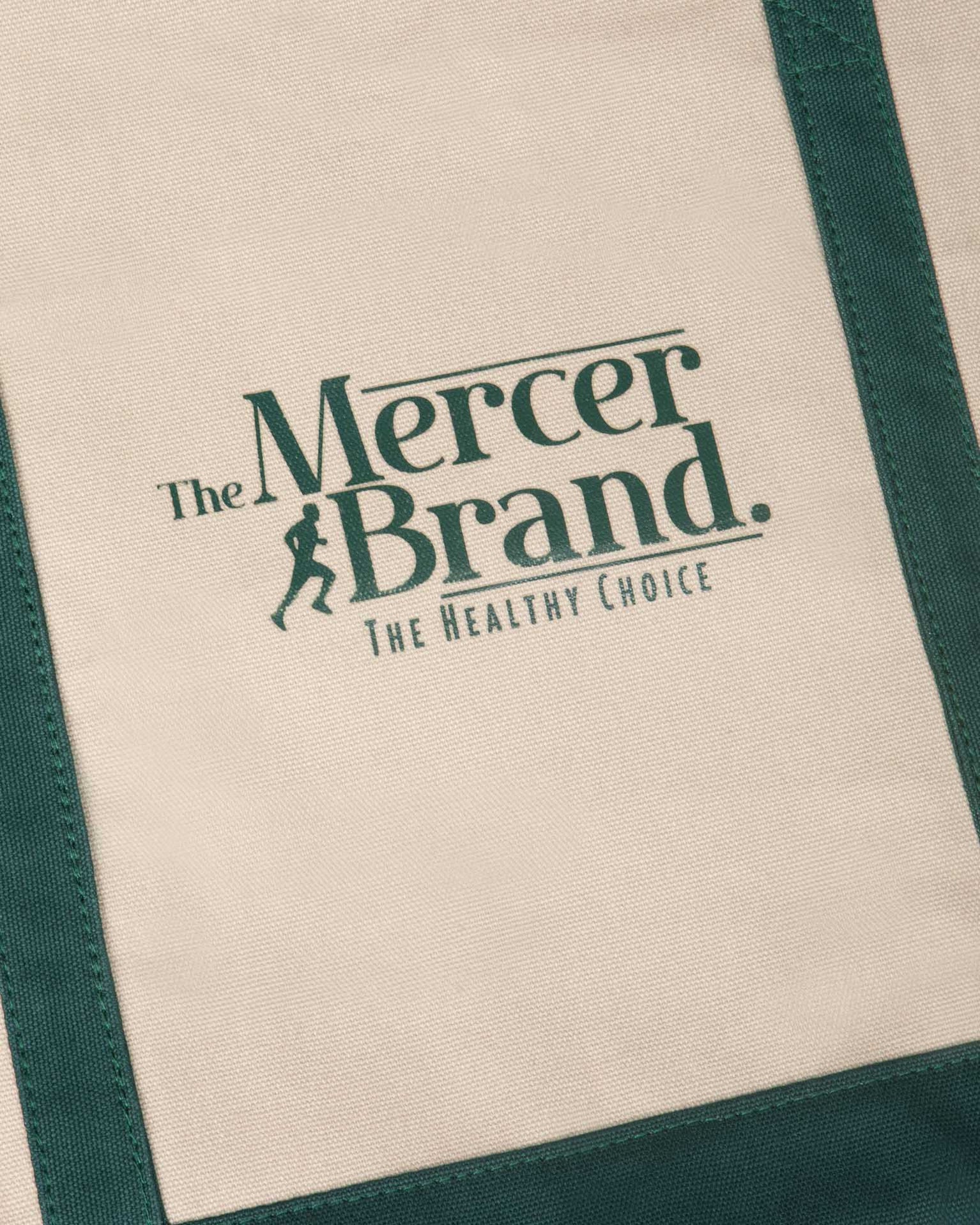 the mercer brand canvas bag with dog and green details 