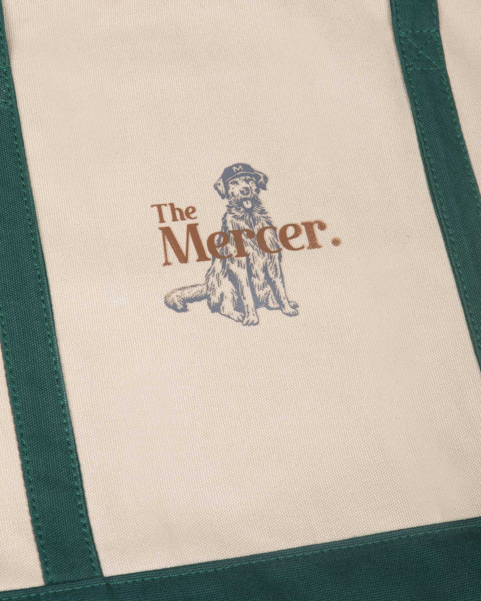 the mercer brand canvas bag with dog and green details 