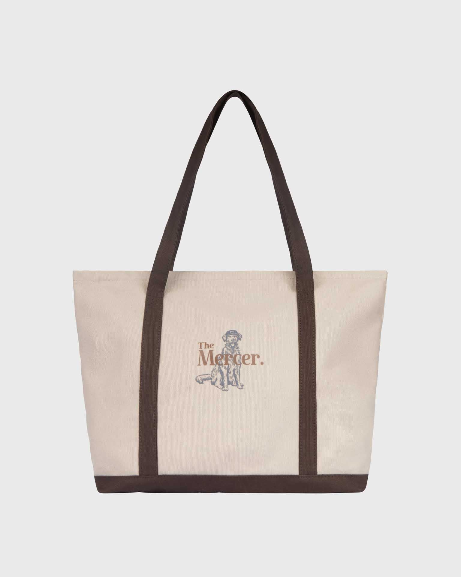 the mercer brand canvas bag brown with logo and dog on other side cream bag with brown details