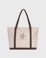 the mercer brand canvas bag brown with logo and dog on other side cream bag with brown details