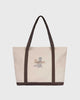 the mercer brand canvas bag brown with logo and dog on other side cream bag with brown details
