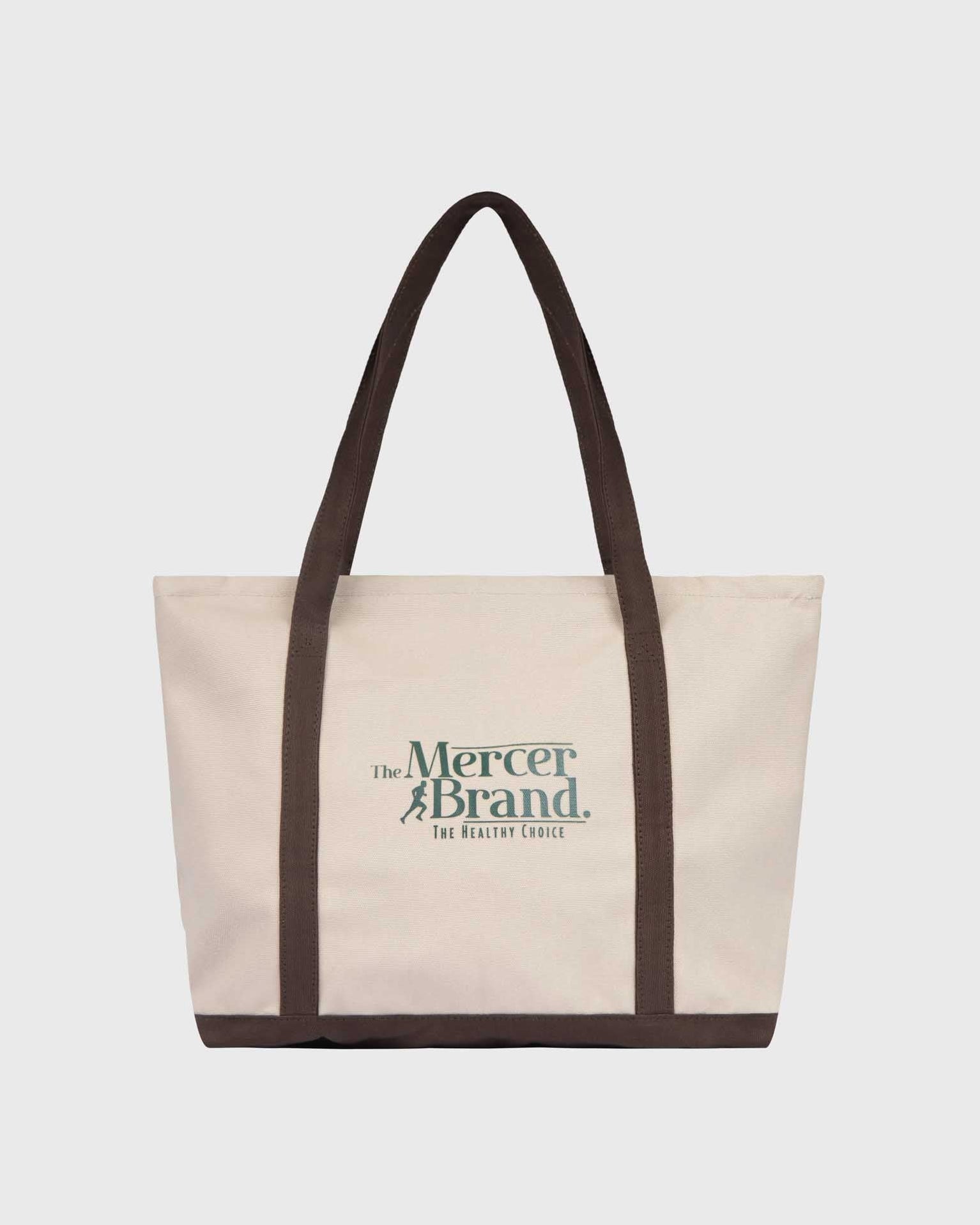 the mercer brand canvas bag brown with logo and dog on other side cream bag with brown details