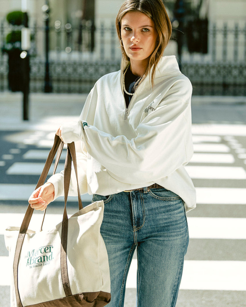 the mercer brand canvas bag brown with logo and dog on other side cream bag with brown details