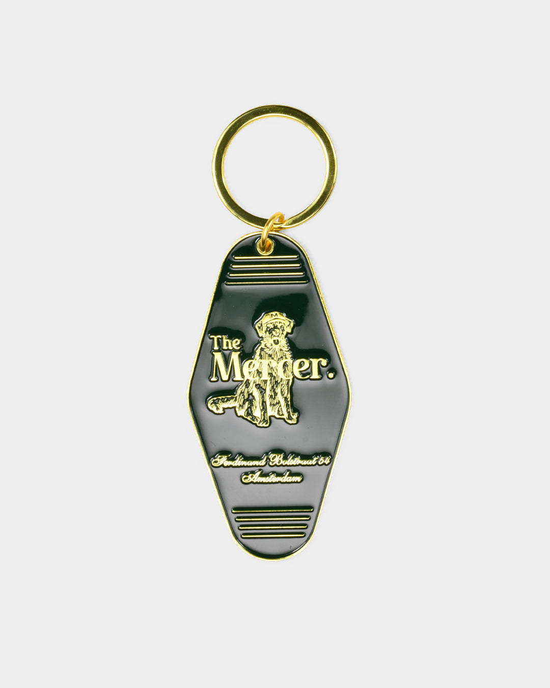 the mercer brand keychain green with gold details with logo and the mercer dog