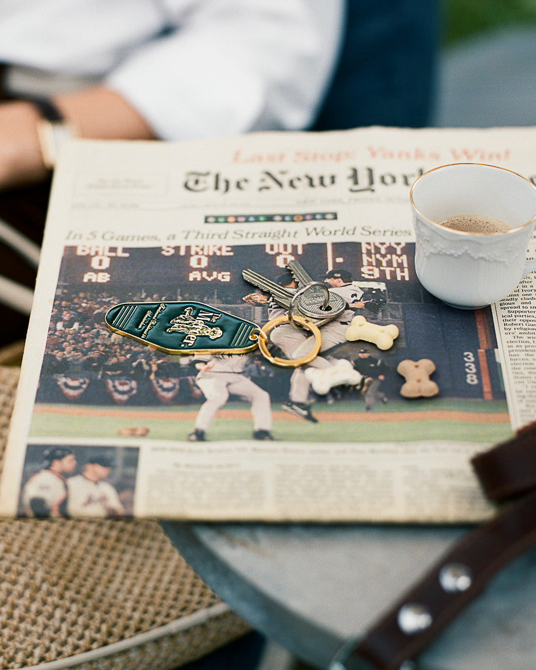 the mercer brand keychain green with gold details with logo and the mercer dog