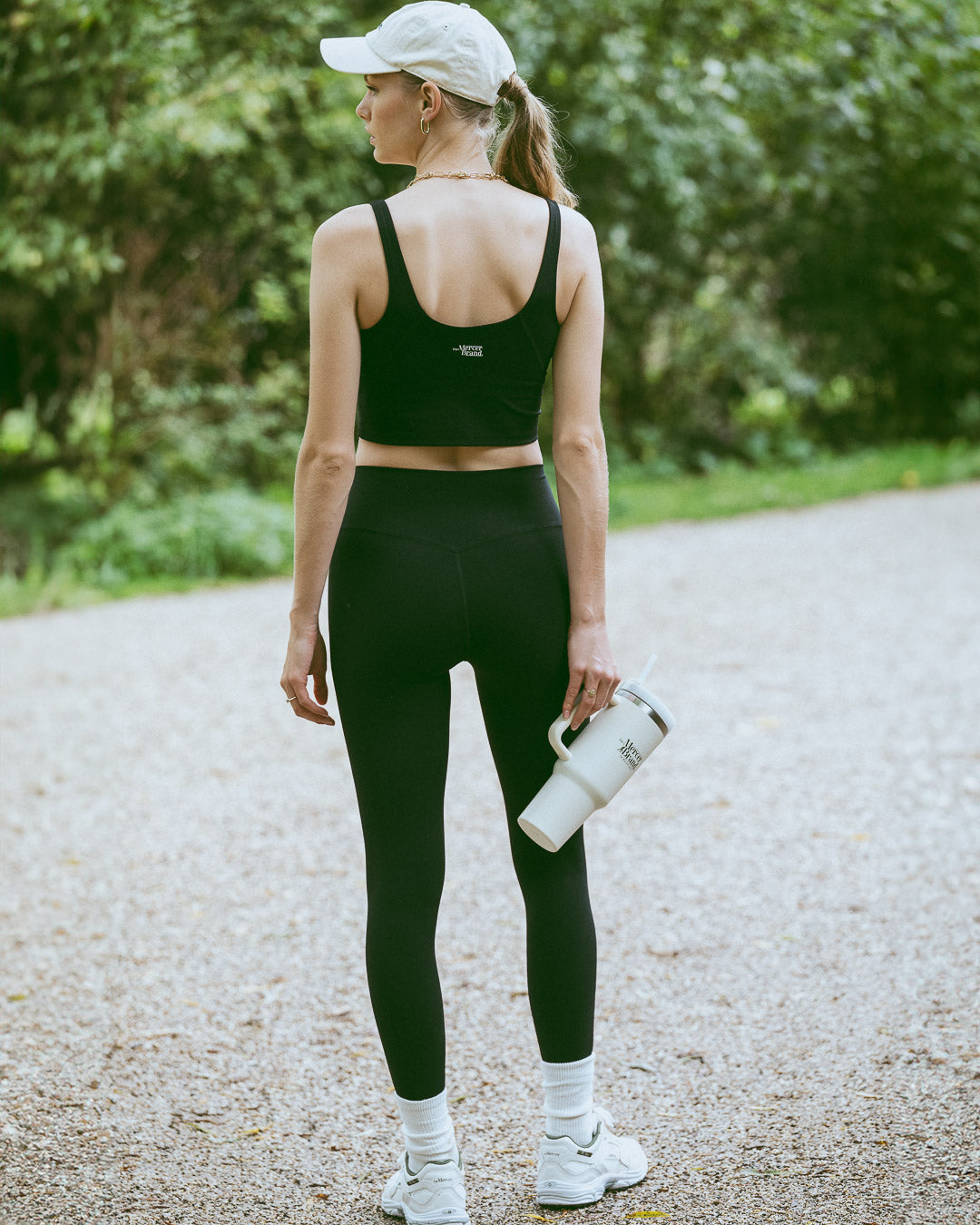 The Mercer Brand cream tumbler with logo on a light grey background