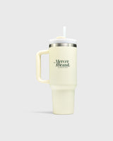 The Mercer Brand cream tumbler with logo on a light grey background