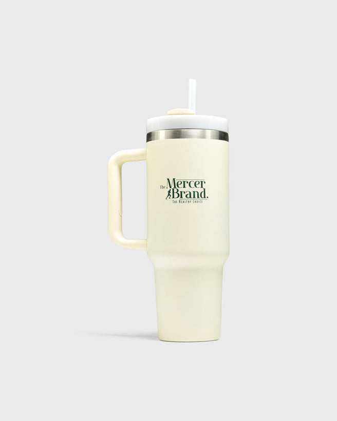 The Mercer Brand cream tumbler with logo on a light grey background