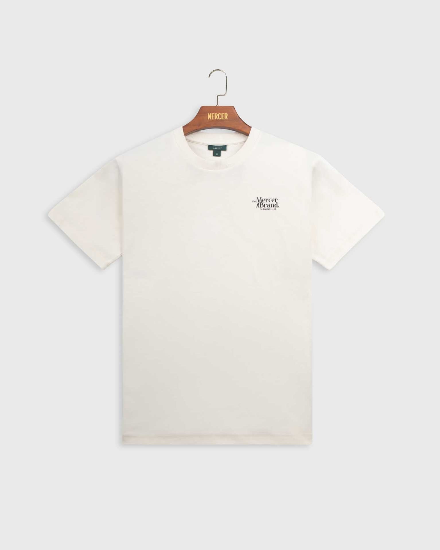 The mercer brand heavy tee off white product photo front with text 