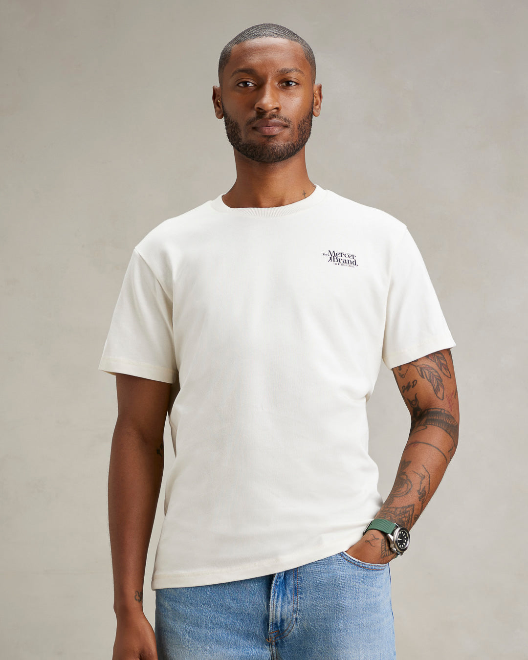 The mercer brand heavy tee off white product photo front with text 