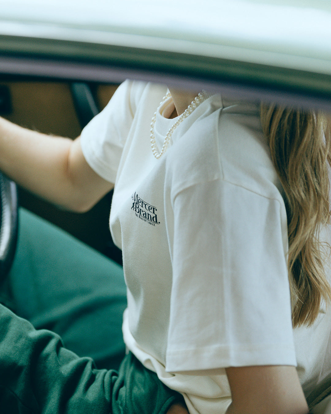 The mercer brand heavy tee off white product photo front with text 