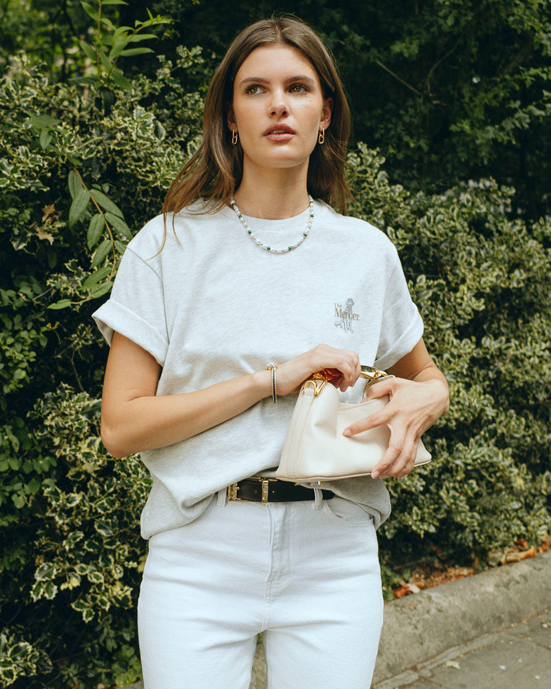 the mercer brand heavy tee with dog shirt for women with  bag in streets of London