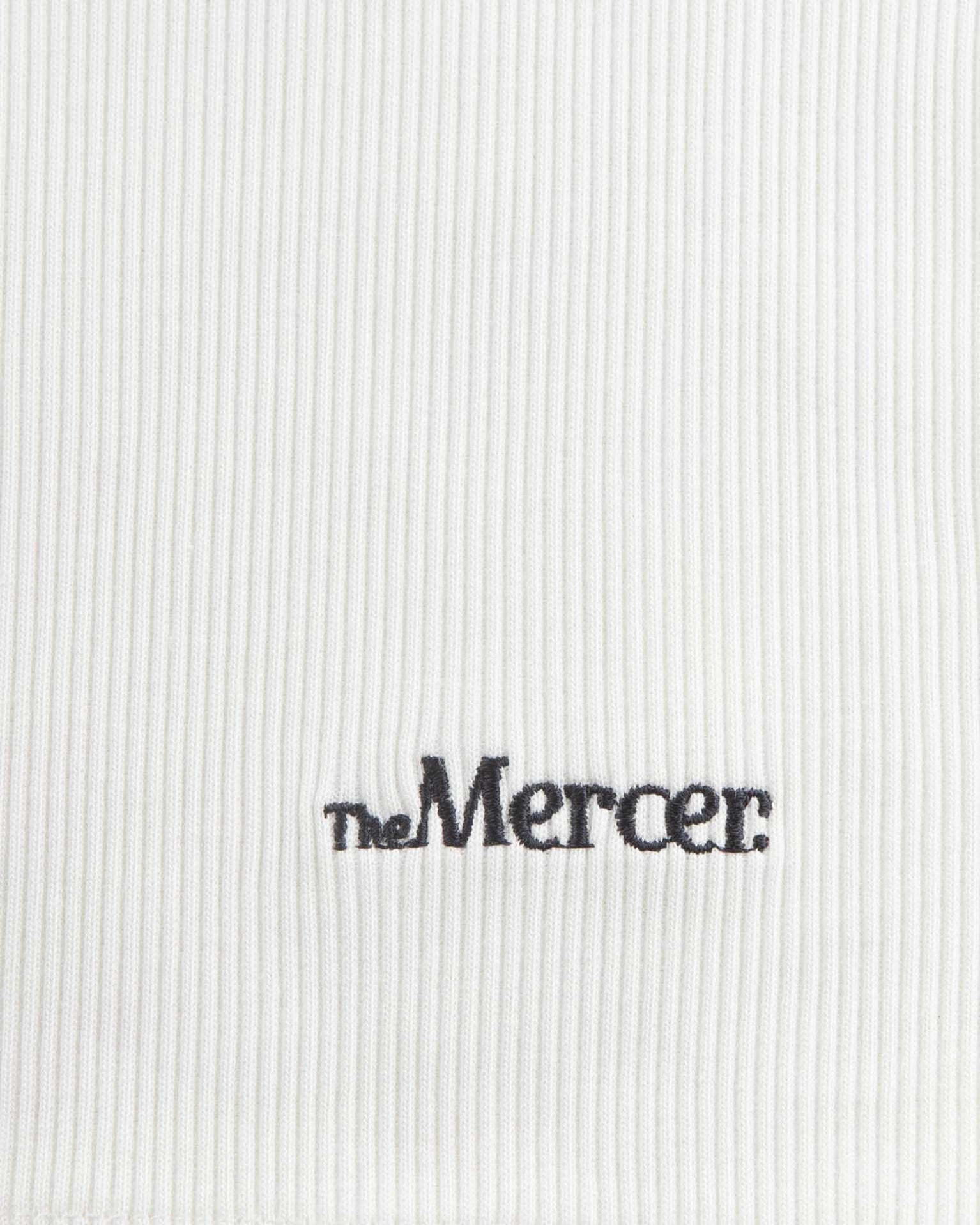 the mercer brand tank top off white on hanger with small detail