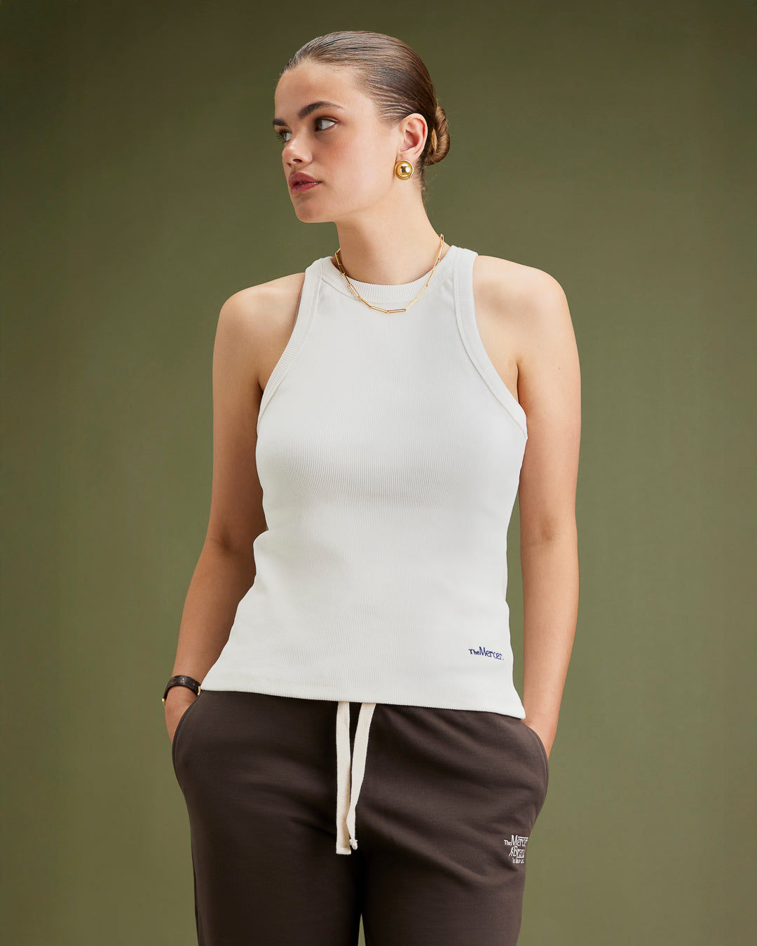 the mercer brand tank top off white on hanger with small detail