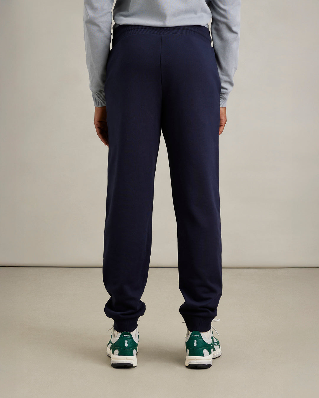 the mercer brand sweatpants navy back styled for men with pineapple sneaker