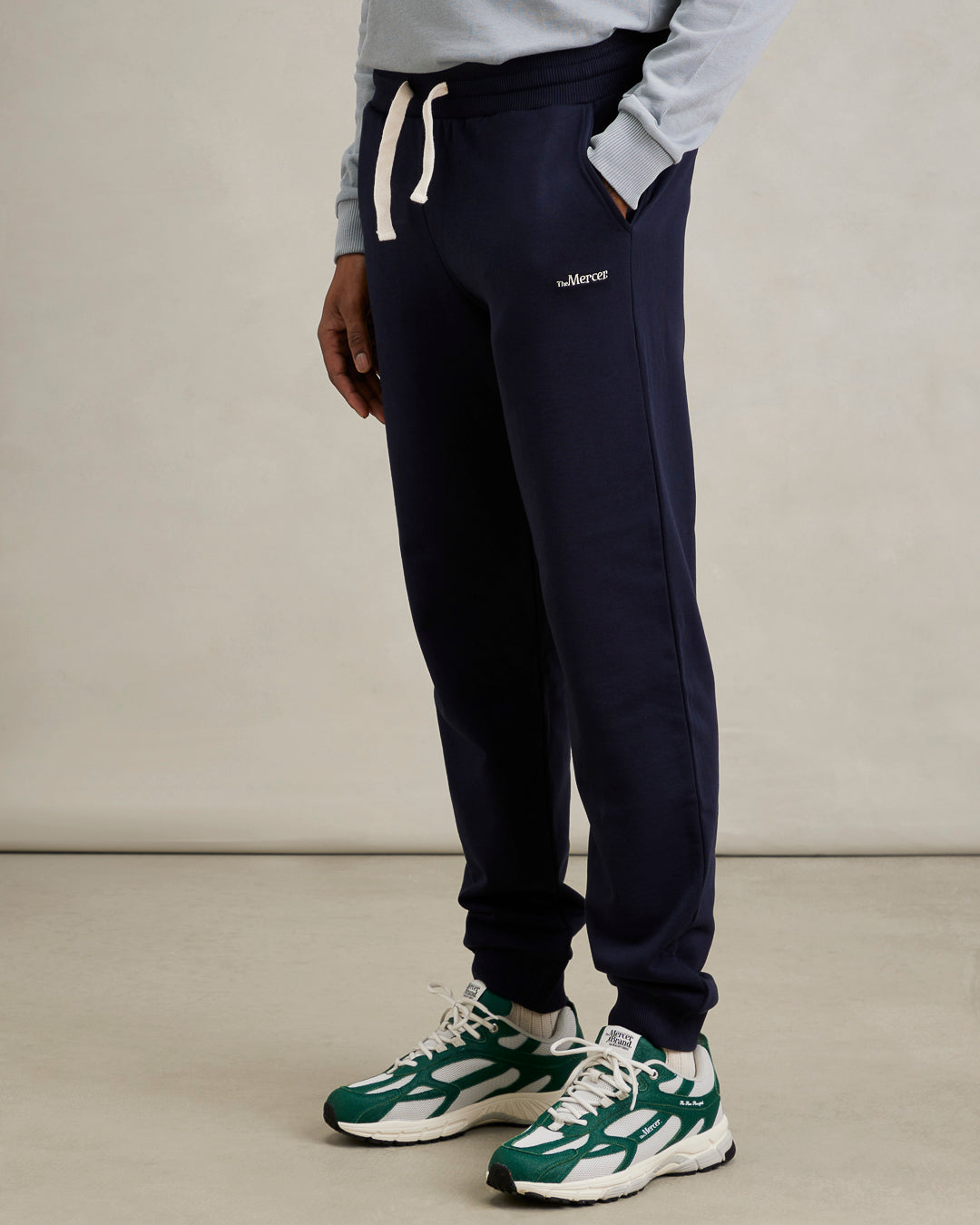 the mercer brand sweatpants navy back styled for men with pineapple sneaker
