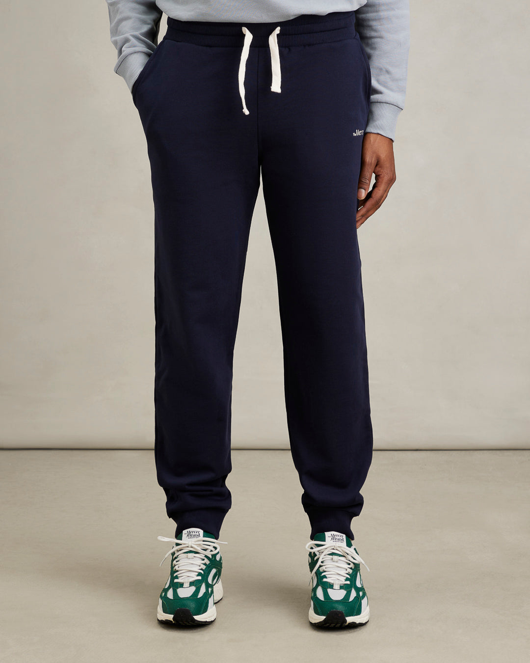 the mercer brand sweatpants navy back styled for men with pineapple sneaker