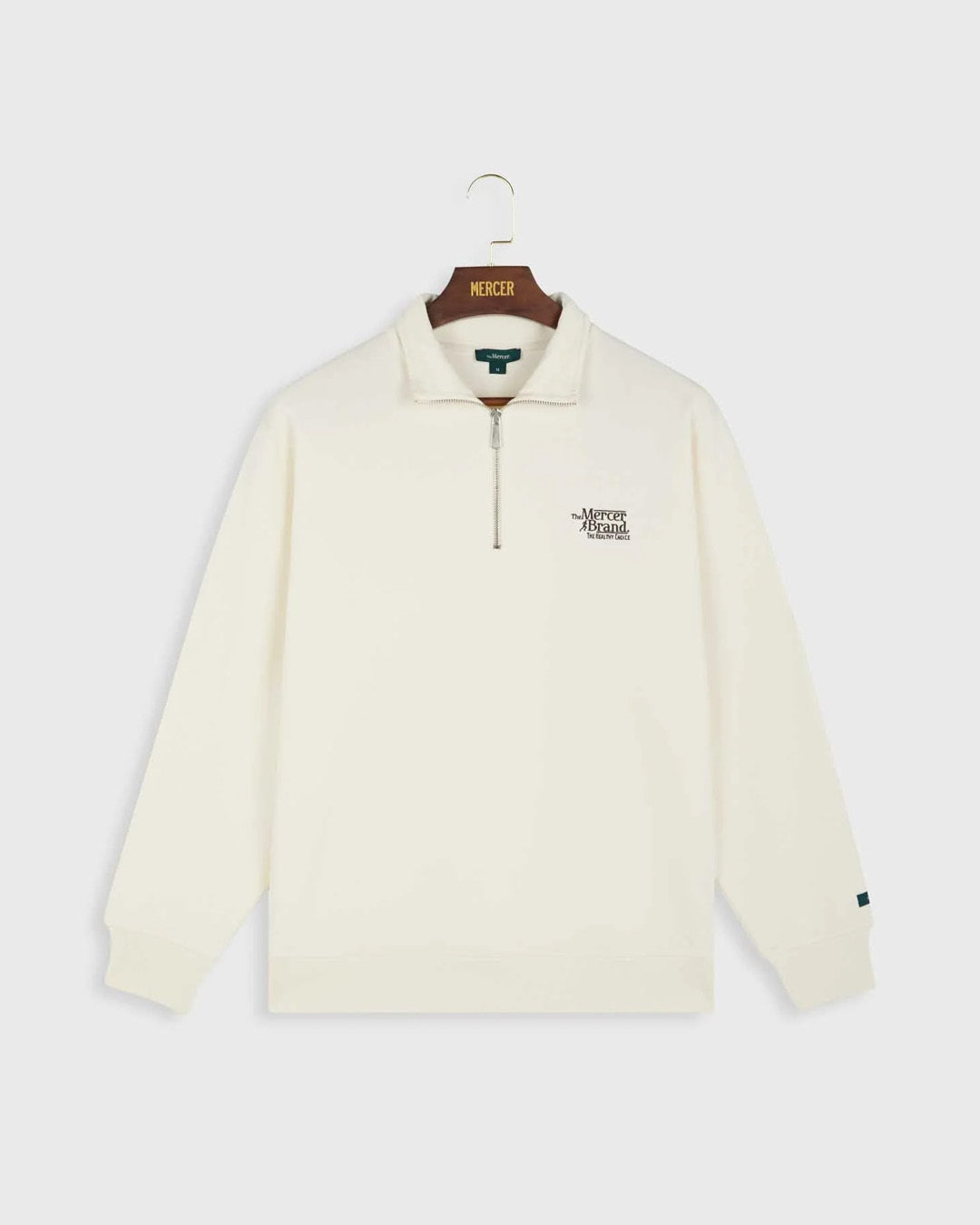 the mercer brand quarter zip off white sweater with zipper and logo front