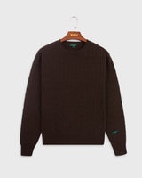 the mercer brand cable knit made from cashmere in brown green logo on arm