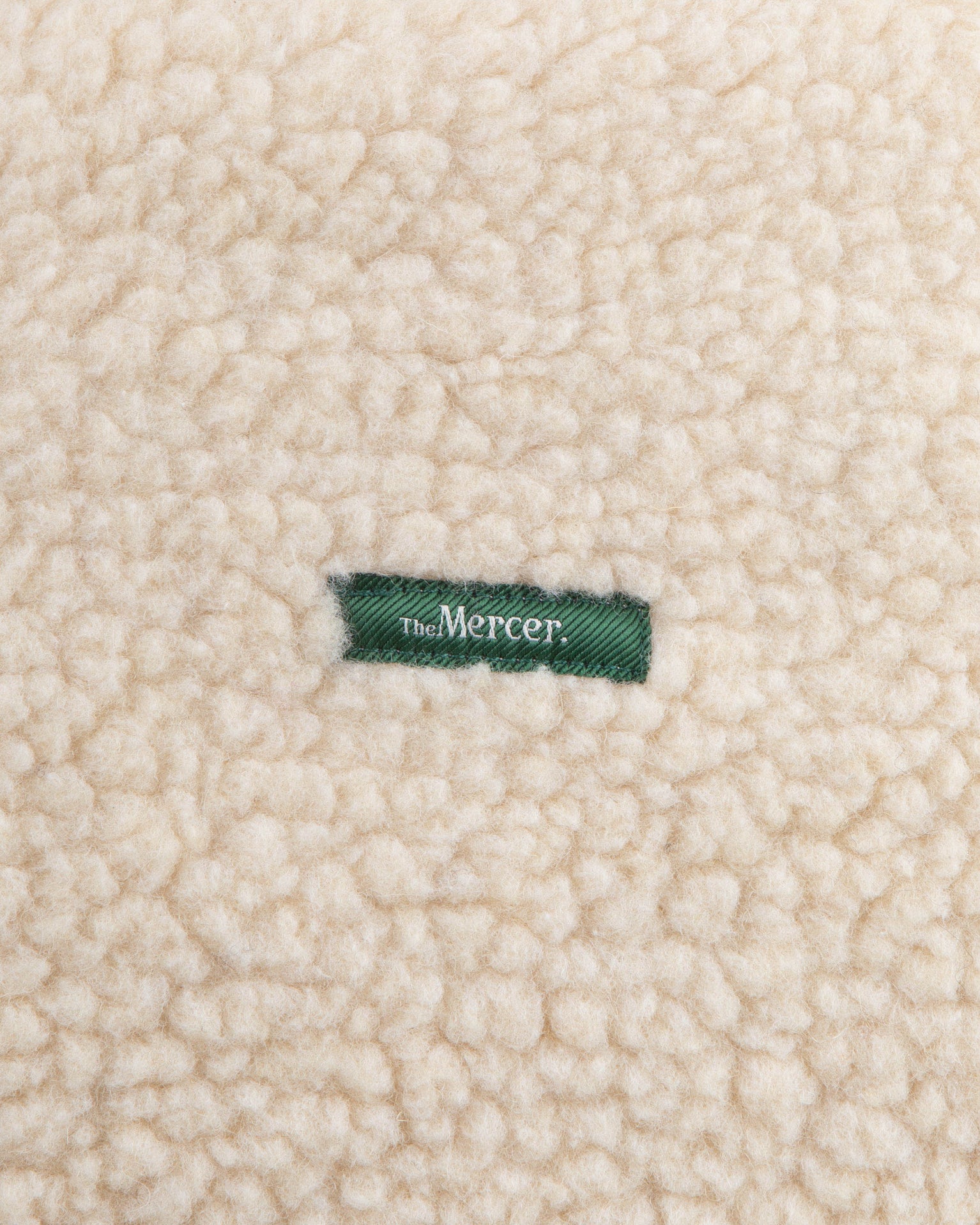 The Mercer wool zip off white with green zippers and green logo product photo front