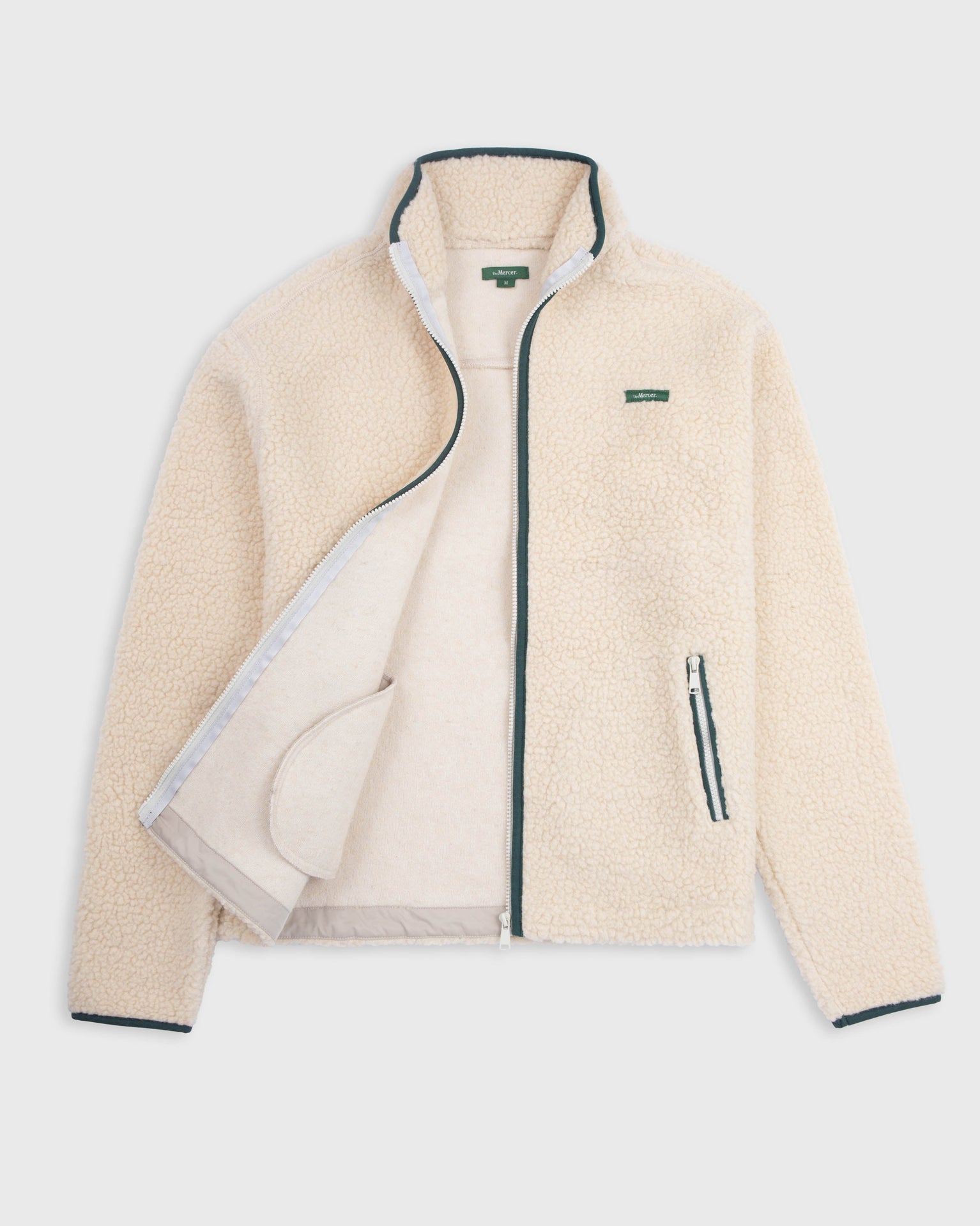 The Mercer wool zip off white with green zippers and green logo product photo front
