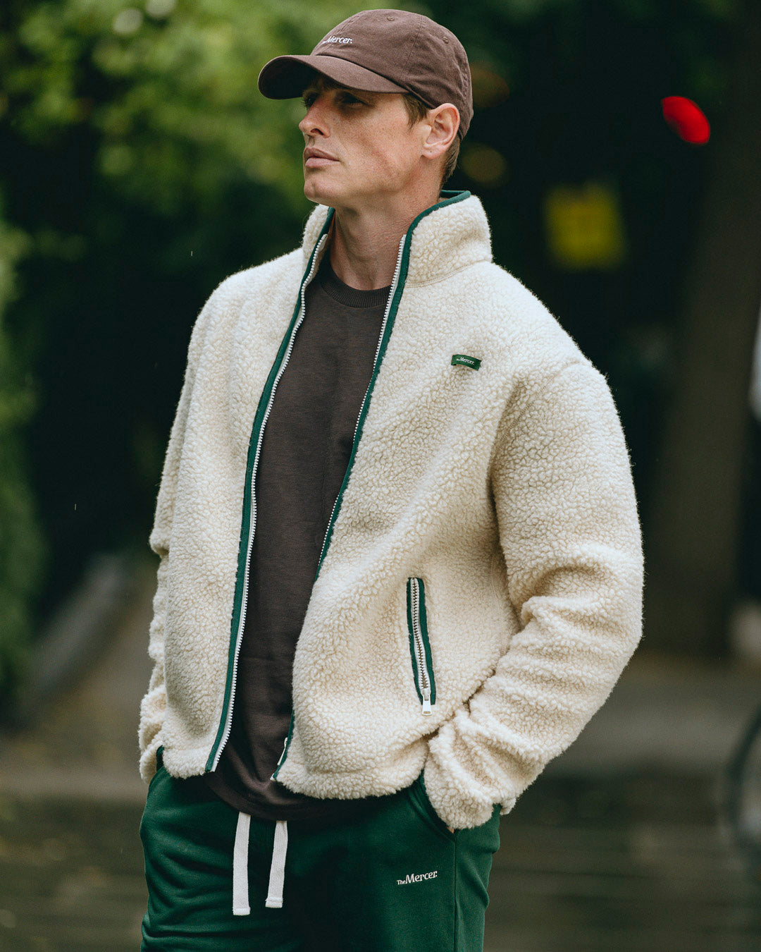 The Mercer wool zip off white with green zippers and green logo product photo front