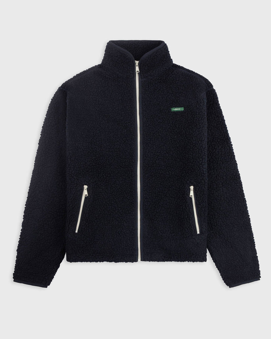 The mercer brand wool zip navy with white zippers and green logo front