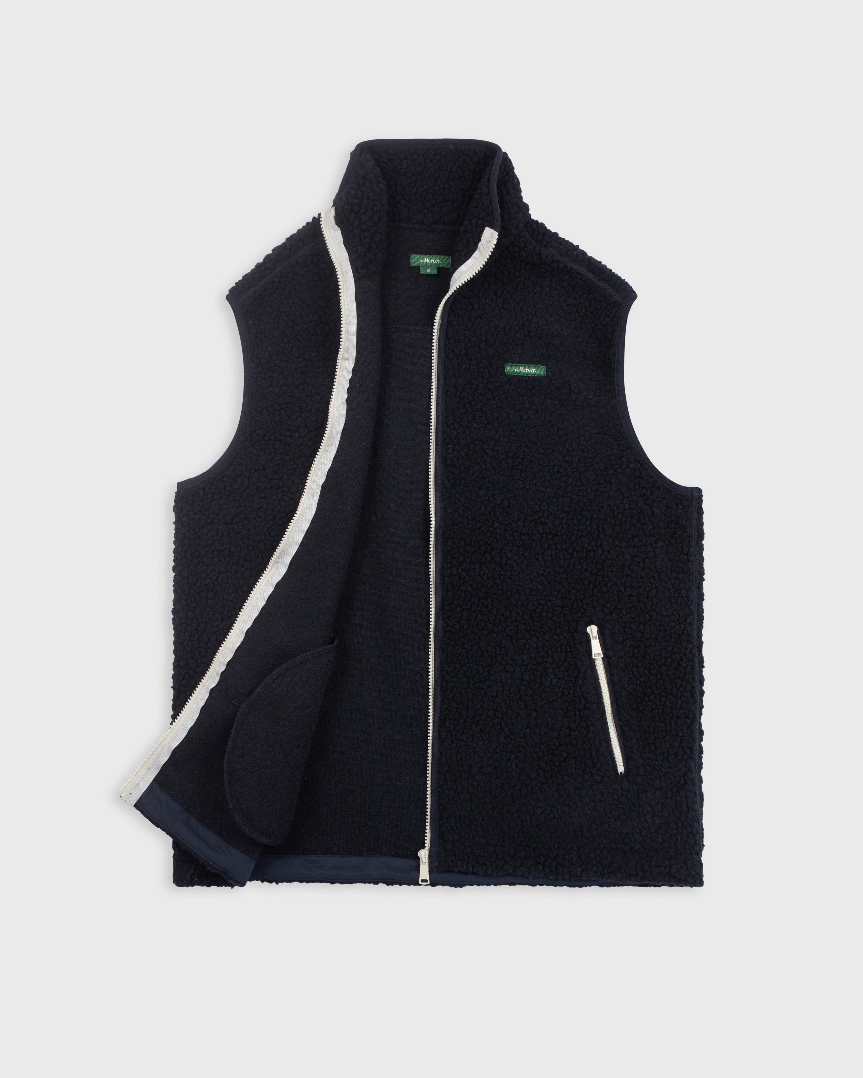 the mercer brand wool bodywarmer navy with green logo