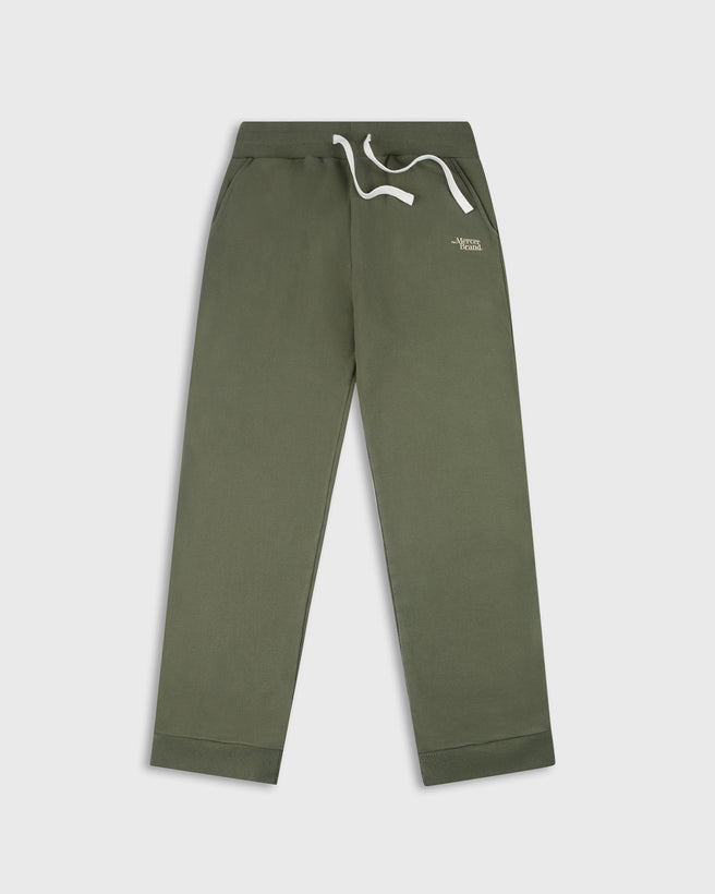 Green The Mercer Brand sweatpants with white drawstring on a light grey background