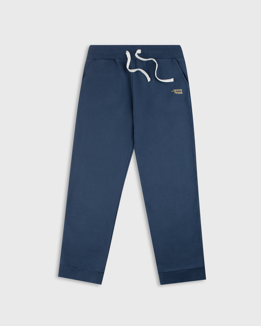 The Mercer Brand navy sweatpants with white drawstring on a light grey background