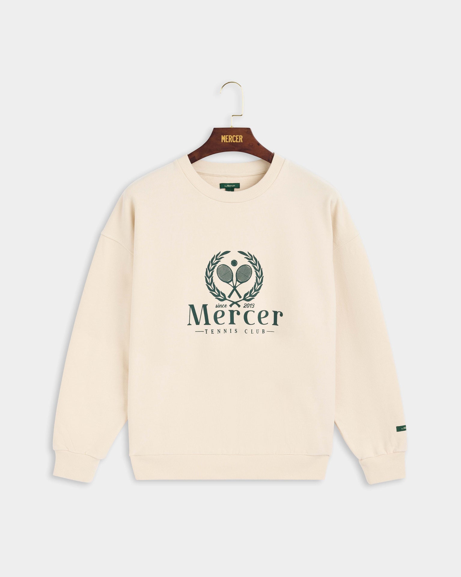 Product photo of the front of The Mercer Tennis Sweat in off white.
