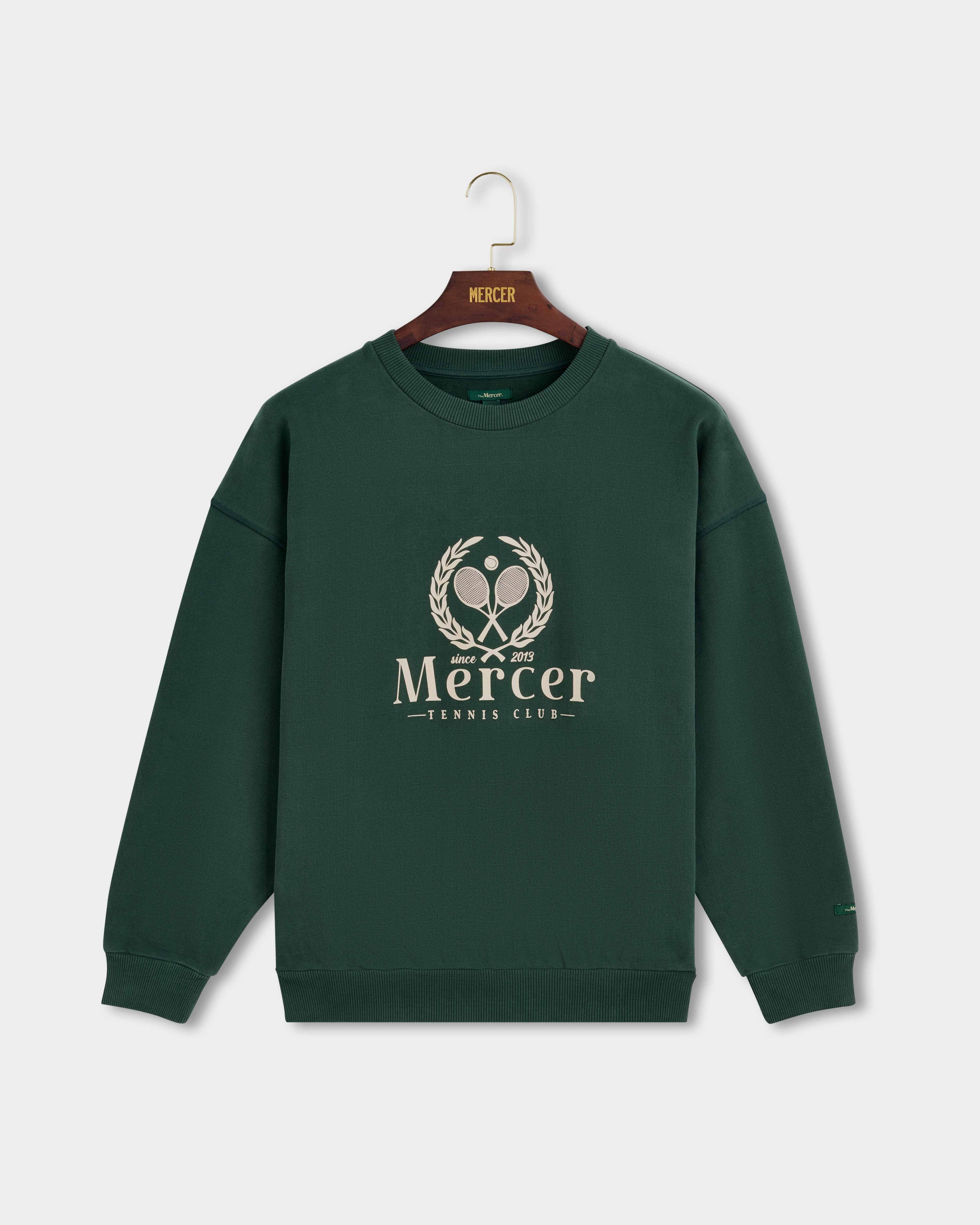 Product photo of the front of The Mercer Tennis Sweat in green.